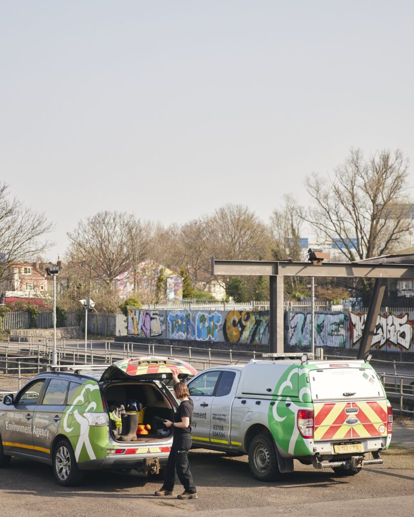 EA vehicles parked in area with railings and graffiti