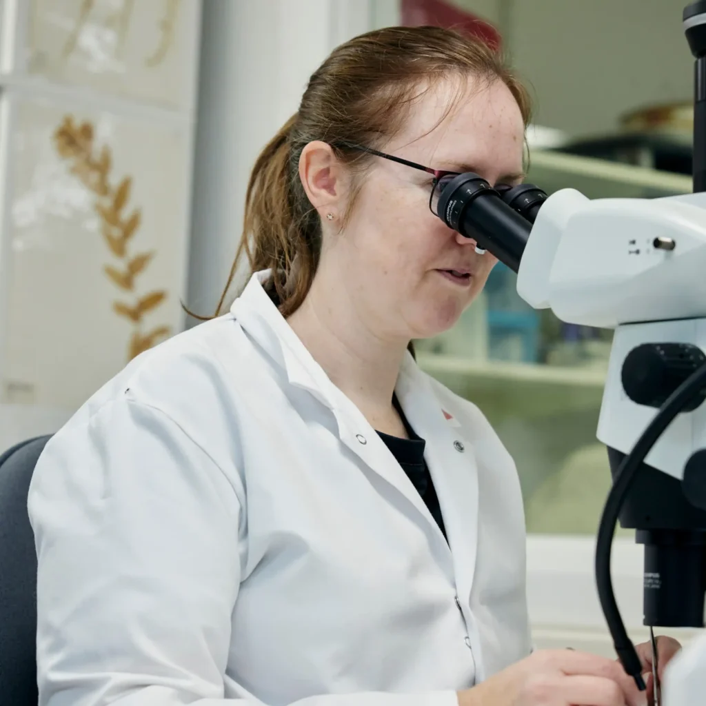 Woman looking through microscope