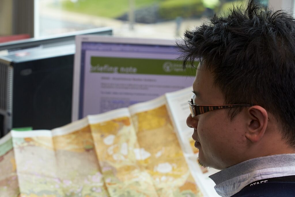 EA team member carrying out maintenance while going through the manual