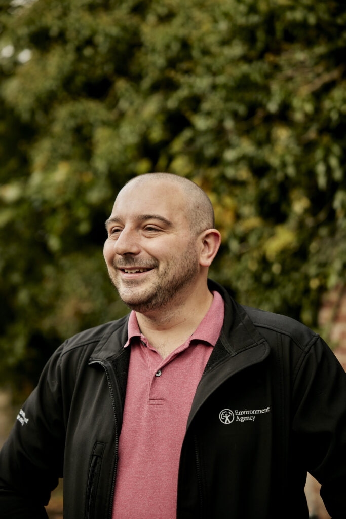 Smiling EA employee in EA jacket.